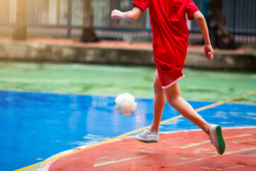 Sticker - futsal player run to shoot ball.  Youth futsal league.