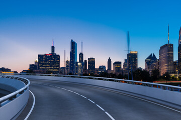 Empty urban asphalt road exterior with city buildings background. New modern highway concrete construction. Concept of way to success. Transportation logistic industry fast delivery. Chicago. USA.