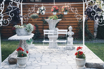 Poster - Relaxing place with wgite chairs and flowers in the garden