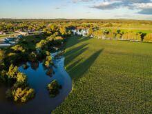 Flooding River Backflowing Over Farm Paddocks, Drowning Farmers Crops