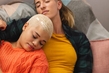 Image Of Happy Diverse Lesbian Couple Sleeping On Sofa
