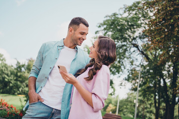 Sticker - Photo of attractive charming lady handsome guy hold telephone look each other free time outside