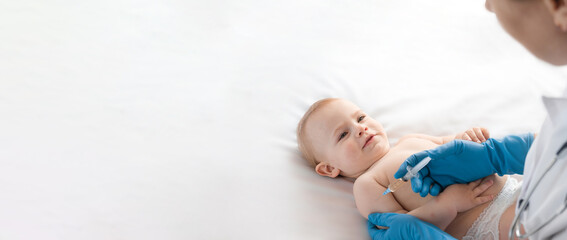 doctor vaccinating baby in clinic. little baby get an injection. pediatrician vaccinating newborn ba