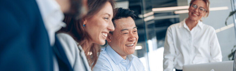 Wall Mural - Close up of smiling confident businesswoman on business meeting with colleagues in office