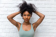 © kanpisut - Portrait of African American woman with bushy curly hairstyle