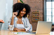 © kanpisut - Young woman consumer holding credit card and laptop buying online at home. Woman shipping online with credit card in hand. Women using  laptop technology paying credit card shopping online