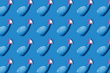 Wall Mural - Blue spray bottles with detergents, cleaning liquid or bleach over blue background. Mockup image, pattern