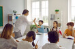 © Studio Romantic - Great job. Well done. Give me a high five. Happy school teacher has good relationships with small children, encourages students to gain new knowledge and motivates for better results and achievements