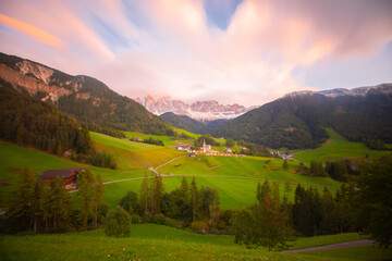 Val di Funes valley photographed with long exposure technique, dolomites alpine mountains in the background