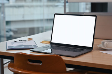 Poster - Laptop computer with blank white screen on office desk in the meeting room.