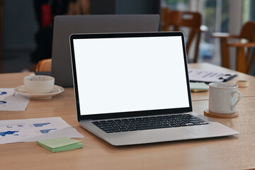 Poster - Modern laptop with empty white screen on the wooden desk in the conference room.