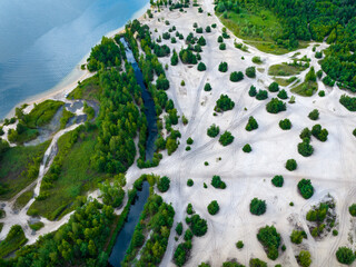 Wall Mural - Summer holiday at the green lake. Rest on the beach, leisure time. Aerial view of small hidden beach surrounded by greenery.