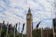 The flags of Parliament Square with Big Ben in the background, London