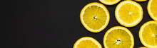 Top View Of Cut And Bright Orange Slices Isolated On Black, Banner.