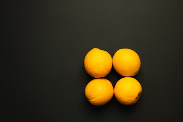 Canvas Print - Top view of sweet oranges in peel isolated on black.