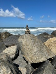 Wall Mural - Vertical shot of rocks on the beach on a sunny day