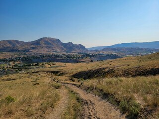 Desert trail over Chelan, WA with small blue lake in the background