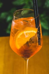 Sticker - Glass cup of Aperol cocktail on a wooden table