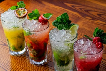 Poster - Closeup of a variety of mojitos in a row on wooden table