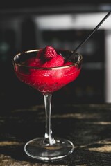 Sticker - Vertical closeup of a glass of raspberry martini on bar counter