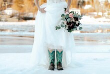 Bride With White Dress Showing Her Cowboy Boots