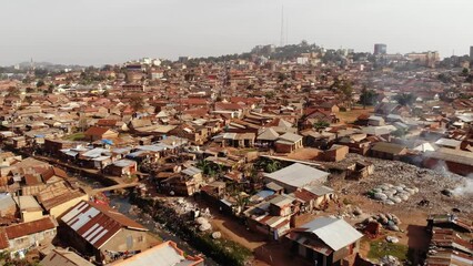 drone shot over the slums of uganda, going backwards. high quality 4k footage