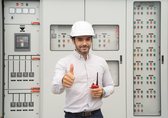 Wall Mural - An engineer man or worker, people working in electrical room. Power energy motor machinery cabinets with panel in control or server room, operator station network in industry factory. Switchgear