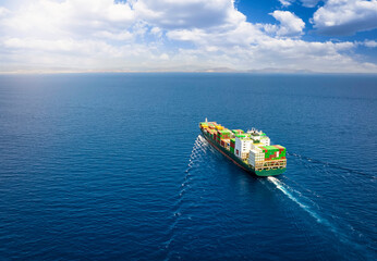 A large cargo container ship traveling over the open ocean as a concept for global trade and shipping