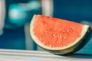 Poster - natural cut watermelon in summer with swimming pool background