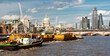 London city skyline,boats and barges drifting along the Thames river,on a warm summer afternoon,London,England,UK.