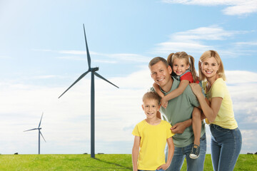 Happy family with children and view of wind energy turbines