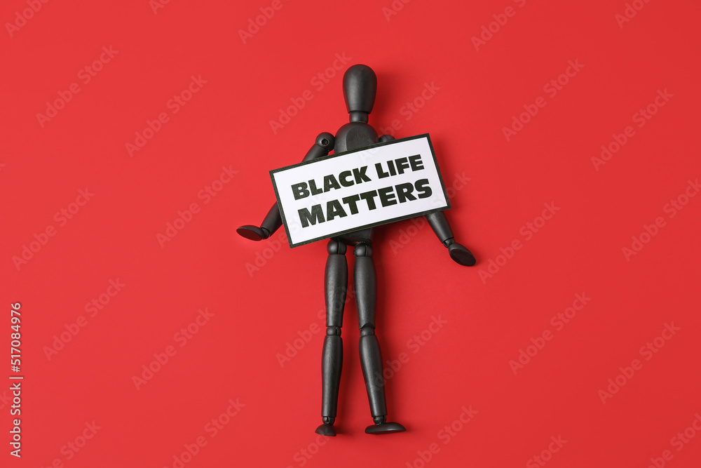 Black mannequin and paper sheet with text BLACK LIFE MATTERS on color background