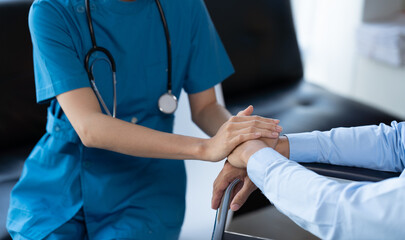 Doctor and patient sitting and talking at medical examination at hospital office, close-up. Therapist filling up medication history records. Medicine and healthcare concept.