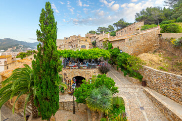 Wall Mural - View from one of the towers of the 12th Century citadel looking into the medieval center of the fortress as tourists enjoy a rooftop garden cafe.