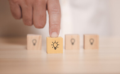 Poster - hand pick wooden blocks with thinking and idea icon. Concept for creative and design solution.