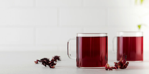 Herbal tea made from hibiscus petals in a transparent cup. Copy space.