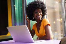 Happy Beautiful Young Black Woman Using Laptop In Cafe