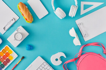 Top view of school supplies on pastel blue background. Creative study idea, flat lay. Minimal back to school concept.