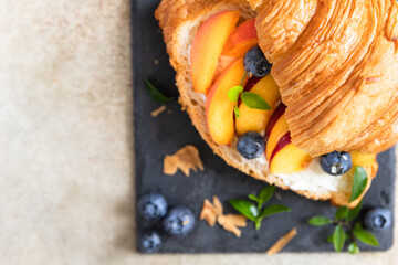 Wall Mural - Vegetarian croissant sandwiches with nectarine, soft or cream cheese, blueberries and honey. Healthy breakfast or lunch.