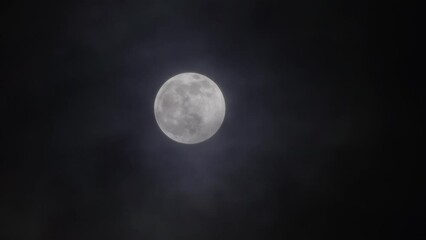 Wall Mural - full moon moving between clouds
