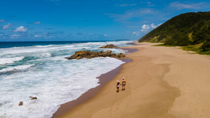 St Lucia South Africa, men and woman walking at the beach Mission Rocks beach near Cape Vidal in Isimangaliso Wetland Park in Zululand. South Africa St Lucia