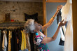© Caia Image - Senior female shop owner arranging display in clothing boutique