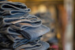 © Caia Image - Close up denim jeans stacked in shop