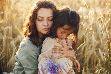 Mother with daughter playing in a summer field