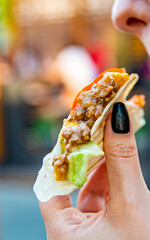 Wall Mural - woman eat taco outdoor traditional in mexican food. street food