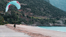 Paraglider  At Landing Moment, Land Touch Steps, Parachute, Sandy Coast, Extreme Sport Activity