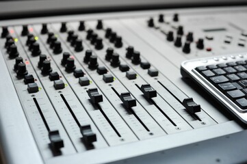 Closeup shot of a mixing console in a recording studio