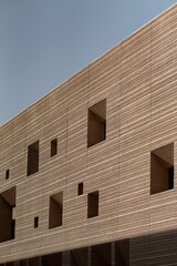 Wall Mural - Vertical sot of a half-constructed building in blue sky background in sunny weather