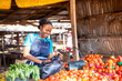 © wazkkii - african market woman shopping from local market