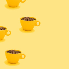 Pattern made of full cup of coffee beans with copy space on bright yellow background. Yellow mug filled with drinking energy for season break. Creative and refreshing vibrant beverage minimal concept